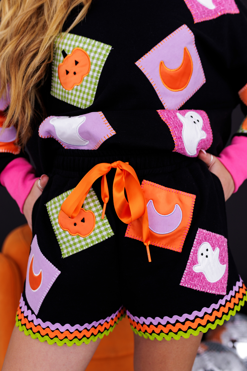 Front view of the Patchwork Halloween Shorts with colorful patches and rickrack hem